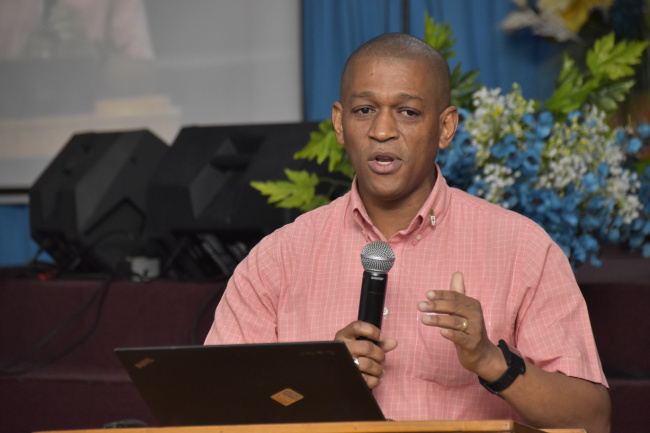 Director, Department of Energy, Dr. Mark Bynoe, gestures as he makes a point during his presentation at the Vreed-en-Hoop Wesleyan Church.