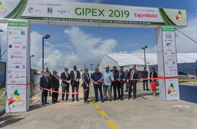 Prime Minister Moses Nagamootoo cuts the ribbon for official entry to the GIPEX exhibition set up in the Marriott parking lot. He was accompanied by several Ministers of Government including Foreign Secretary at the Ministry of Foreign Affairs, Carl Greenidge; Director, Department of Energy, Dr Mark Bynoe and CEO of GO-Invest, Owen Verwey (Delano Williams photo)